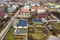 Aerial top view of residential house with team of workers installing solar photo voltaic panels system on roof. Renewable energy Royalty Free Stock Photo