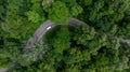 Aerial top view of road in green tree forest, Top view from drone of rural road, mountains, forest. Beautiful landscape with Royalty Free Stock Photo