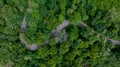 Aerial top view of road in green tree forest, Top view from drone of rural road, mountains, forest. Beautiful landscape with Royalty Free Stock Photo