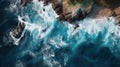 Aerial top view of rocky coast in sea, blue waves of ocean and stones Royalty Free Stock Photo