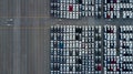 Aerial top view rows of new cars parked in distribution center on car factory, Automobile and automotive car parking lot for Royalty Free Stock Photo