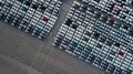 Aerial top view rows of new cars parked in distribution center on car factory, Automobile and automotive car parking lot for Royalty Free Stock Photo