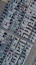 Aerial top view rows of new cars parked in distribution center on car factory, Automobile and automotive car parking lot for Royalty Free Stock Photo