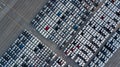 Aerial top view rows of new cars parked in distribution center on car factory, Automobile and automotive car parking lot for