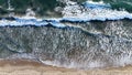 Aerial top view of sea waves against the beach Royalty Free Stock Photo