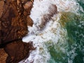 Aerial top view of sea waves hitting rocks on the cliffs Royalty Free Stock Photo