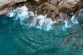 Aerial top view of sea waves hitting rocks Royalty Free Stock Photo