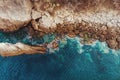 Aerial top view of sea waves and stone rocky beach coast, drone photo