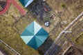 Aerial top view of shingle roof of kindergarten or modern school building on colorful playground in sunny yard background Royalty Free Stock Photo