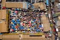 Aerial top view shot of a bunch of people holding umbrellas walking in a market in Ghana Royalty Free Stock Photo