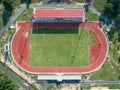 Aerial top view on a soccer field, grandstand, football field with red running track. race track in a stadium. Royalty Free Stock Photo