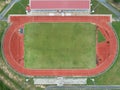 Aerial top view on a soccer field, grandstand, football field with red running track Royalty Free Stock Photo
