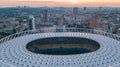 Aerial top view of stadium and Kyiv cityscape on sunset from above, Kiev skyline, Ukraine