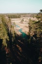 Aerial top view of summer green trees in forest in rural Latvia whit blue woods river.