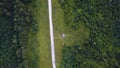Aerial top view of summer green trees, river, roads in forest background. Aerial view of crooked path of road on the Royalty Free Stock Photo