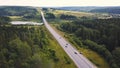 Aerial top view of summer green trees, river, roads in forest background. Aerial view of crooked path of road on the Royalty Free Stock Photo