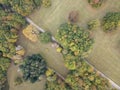 Aerial top view of summer park landscape with green trees, lawns and footpath. Nature background concept