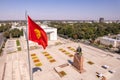 Aerial top view to Flag Kyrgyzstan. Monument Epic Statue of Aykol Manas - kyrgyz hero on Ala-Too Square. State History Royalty Free Stock Photo