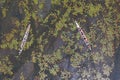 Aerial top view of a tourist boat pink lotus flowers in pond or lake in national park in Thale Noi, Songkhla, Thailand