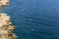 Aerial top view of traditional wooden fishing boats in Valletta Grand Harbor, Malta, with turquoise sea and sandstone rocks Royalty Free Stock Photo