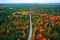 Aerial top view travel drive autumn road in yellow forest, concept of trip by red car Royalty Free Stock Photo