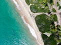 Aerial top view of tropical white sand beach and turquoise clear sea water with small waves and palm trees background. Royalty Free Stock Photo