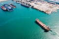 Aerial top view Tugboat drag Oil ship tanker on green sea going to shipyard repair