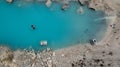 Aerial top view on turquoise water lake surrounded by rocks and sand