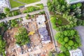 Aerial top view of urban area construction site with high yellow tower crane Royalty Free Stock Photo