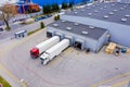 Aerial Top View of White Semi Truck with Cargo Trailer Parking with Other Vehicles on Special Parking Lot