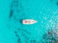 Aerial top view white yacht with sail stands on coral reef in blue transparent turquoise sea. Concept travel Royalty Free Stock Photo