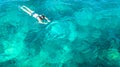 Aerial top view of woman snorkeling from above, girl snorkeler swimming in a clear tropical sea water with corals Royalty Free Stock Photo