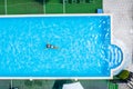 Aerial top view of woman in swimming pool water from above, tropical vacation concept Royalty Free Stock Photo