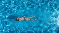 Aerial top view of woman in swimming pool water from above, tropical vacation holiday Royalty Free Stock Photo