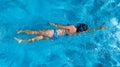 Aerial top view of woman in swimming pool water from above, tropical vacation concept Royalty Free Stock Photo