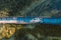 Aerial top view of wooden bridge pathway over marshy river, summer travel concept Royalty Free Stock Photo