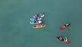 Aerial top view of young people doing standup paddleboarding. Video. Summer and vacation concept, flying over attractive Royalty Free Stock Photo