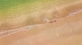 Aerial top view of young woman in bikini relaxing on sand tropical beach by sea and waves from above, girl on tropical island Royalty Free Stock Photo