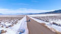 AERIAL: Tourists on a fun winter road trip drive along scenic highway in Montana