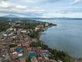 Aerial of the town of Talisay, Batangas and the coast of Taal lake. Mount Banahaw visible at the upper left of photo