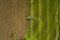 Aerial: The tractor harvester on the field