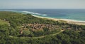 Aerial traditional village with ornated roofs houses at sea sand coast. Indonesia tourist attraction