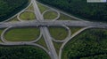 AERIAL. Traffic interchange. Top view of the road, city and forest. Summer video from the drone. Royalty Free Stock Photo