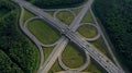 AERIAL. Traffic interchange. Top view of the road, city and forest. Summer video from the drone. Royalty Free Stock Photo