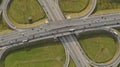 AERIAL. Traffic interchange. Top view of the road, city and forest. Summer video from the drone. Royalty Free Stock Photo