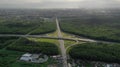 AERIAL. Traffic interchange. Top view of the road, city and forest. Summer video from the drone. Royalty Free Stock Photo