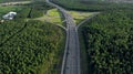 AERIAL. Traffic interchange. Top view of the road, city and forest. Summer video from the drone. Royalty Free Stock Photo