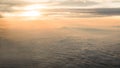 Aerial traveling. Flying at dusk or dawn. Fly through orange cloud and sun