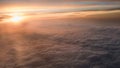 Aerial traveling. Flying at dusk or dawn. Fly through orange cloud and sun Royalty Free Stock Photo