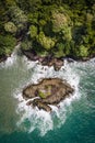 Aerial Tropical island with small waves and rocks